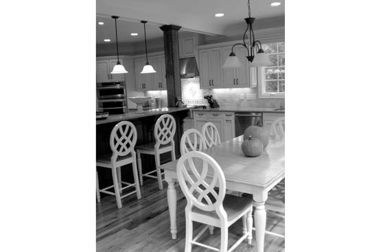 Custom dining area and kitchen remodeling by ETL construction with custom lighting fixtures and cabinetry.
